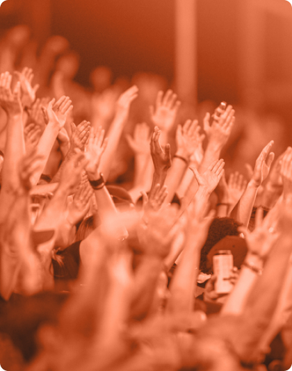 A crowd raising hands at an event.